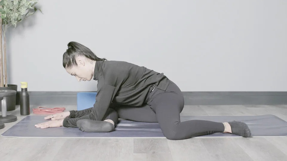 90-90 hip stretch performed on a yoga mat