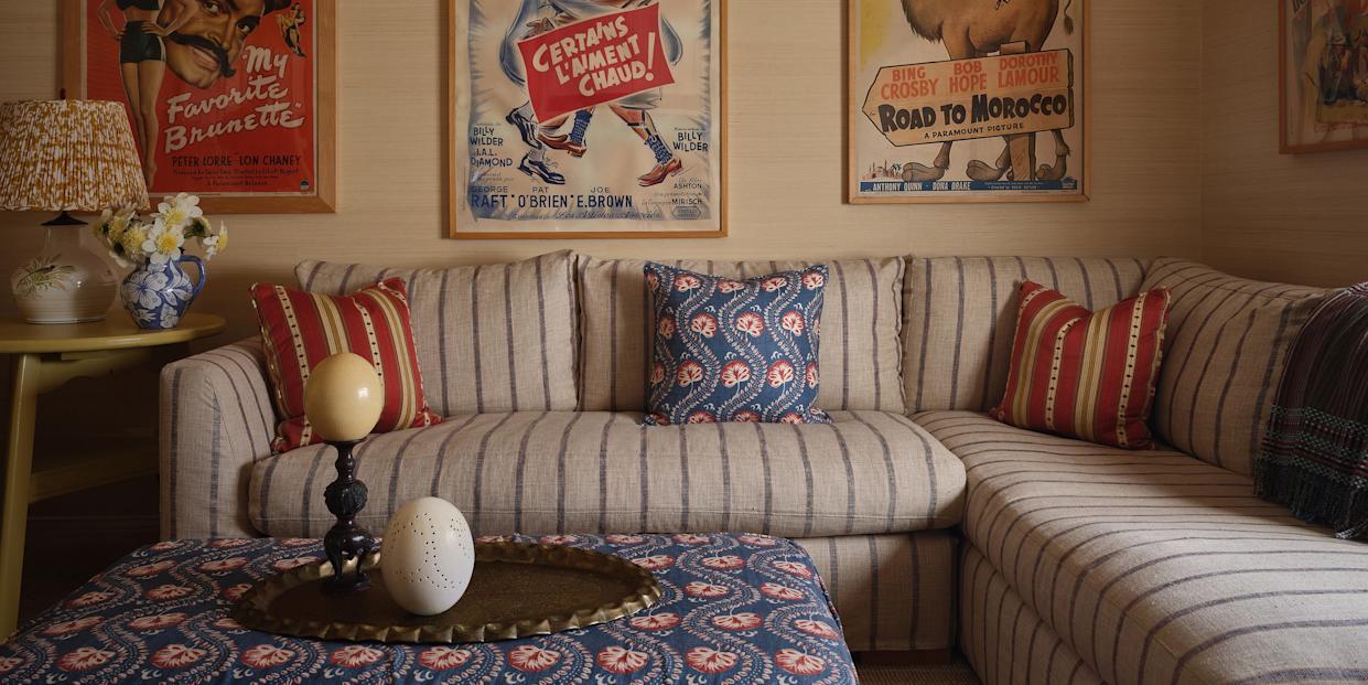 Living room with vintage movie posters and a cozy seating area.
