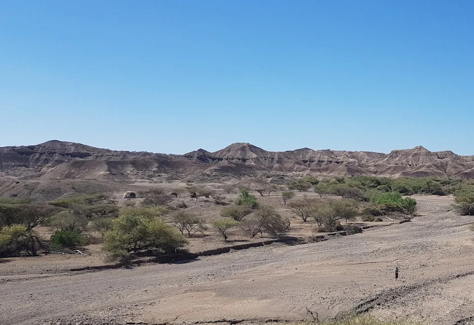 A dry valley landscape with layers in the rock.