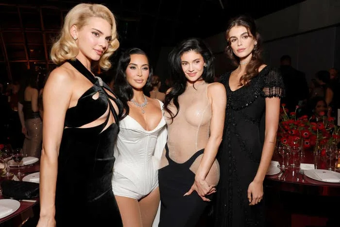 Kendall Jenner, Kim Kardashian, Kylie Jenner, and Kaia Gerber at an event in elegant attire