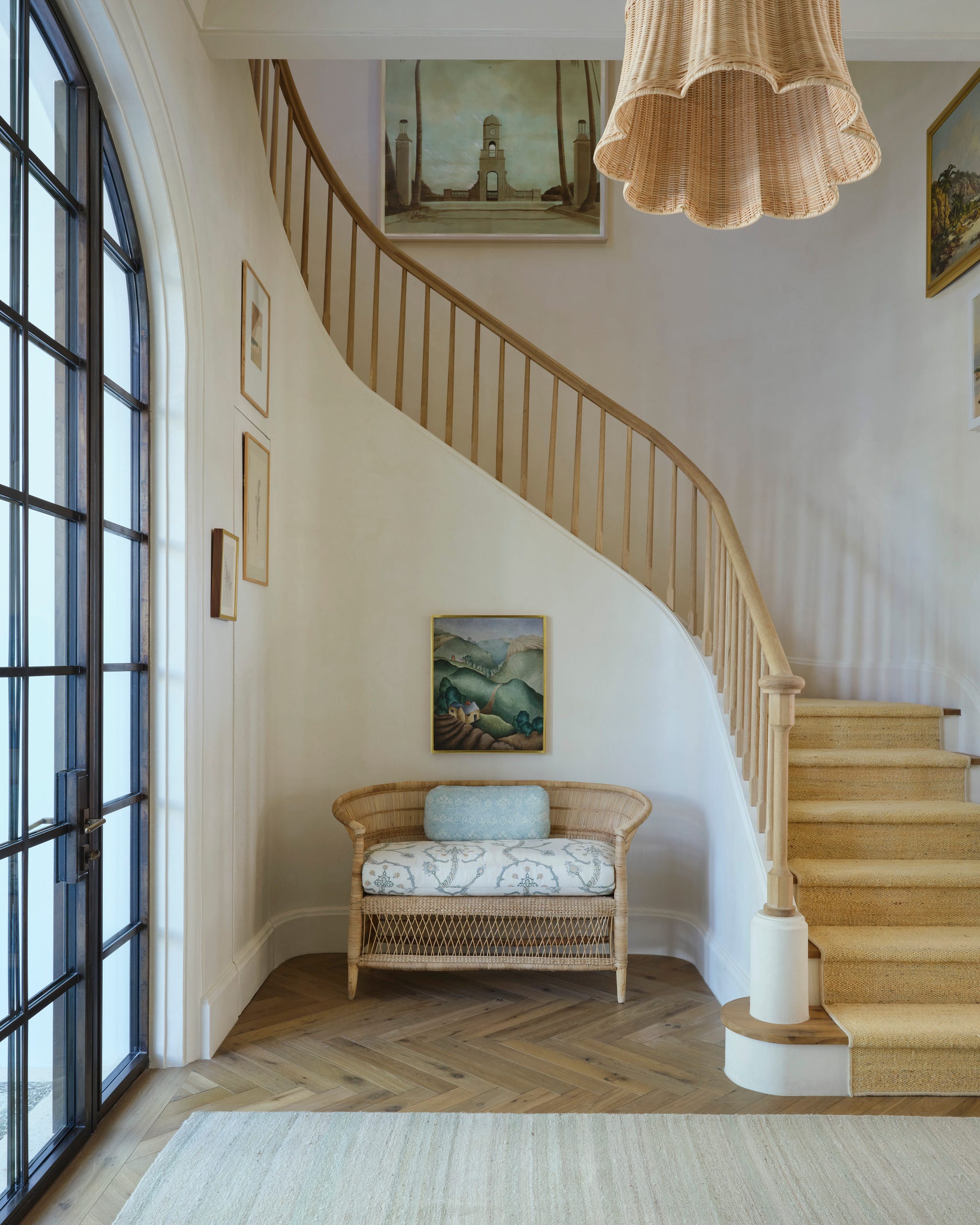 Interior hallway with staircase and seating area.