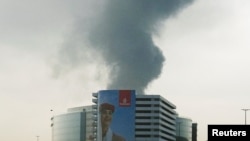 Smoke rises from the Dubai International Airport on March 16, after a Iranian drone hit a fuel tank.