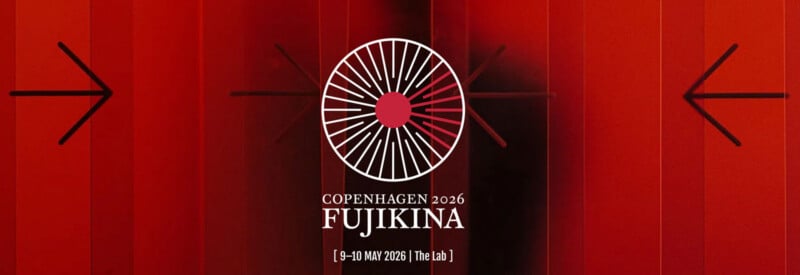 A circular white and red Fujifilm logo is centered on a red background with black arrows pointing left and right. Text below reads: "Copenhagen 2026 Fujikina [9–10 May 2026 | The Lab]".