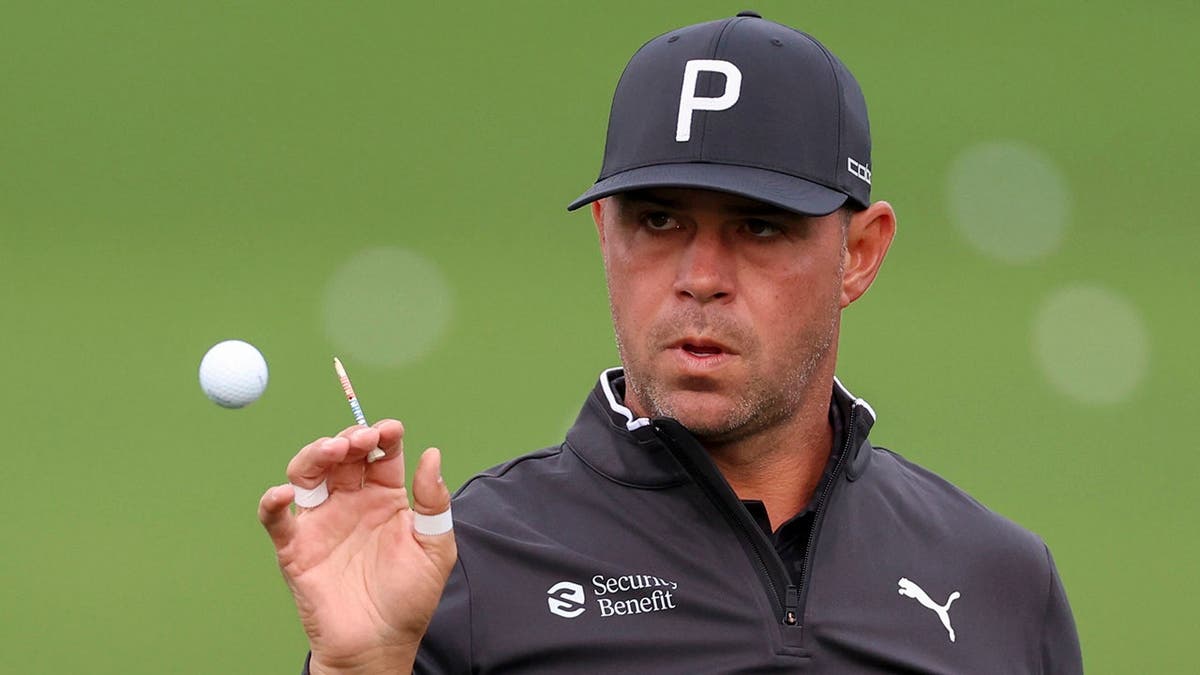 Gary Woodland hitting golf balls at practice facility Augusta National Golf Club