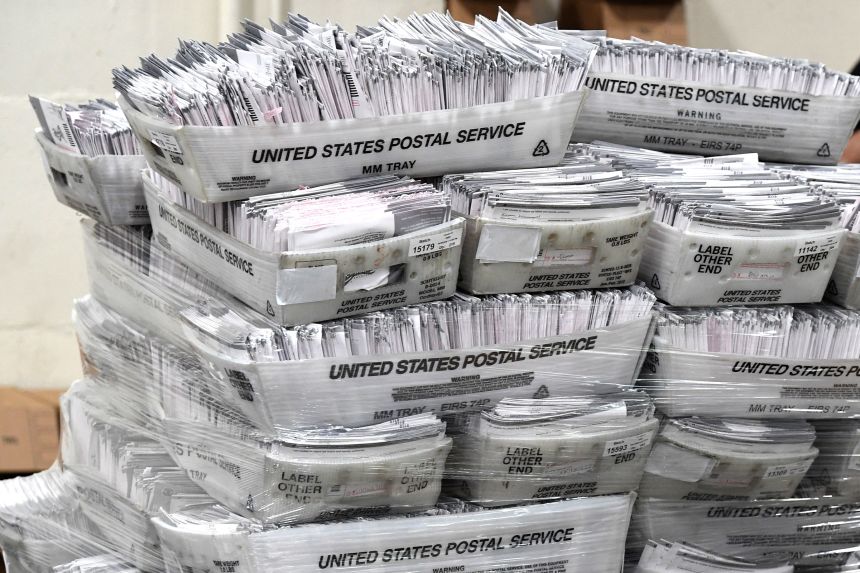 Mail-in ballots in their envelopes await processing at the Los Angeles County Registrar Recorders' mail-in ballot processing center at the Pomona Fairplex in Pomona, California, on October 28, 2020.
