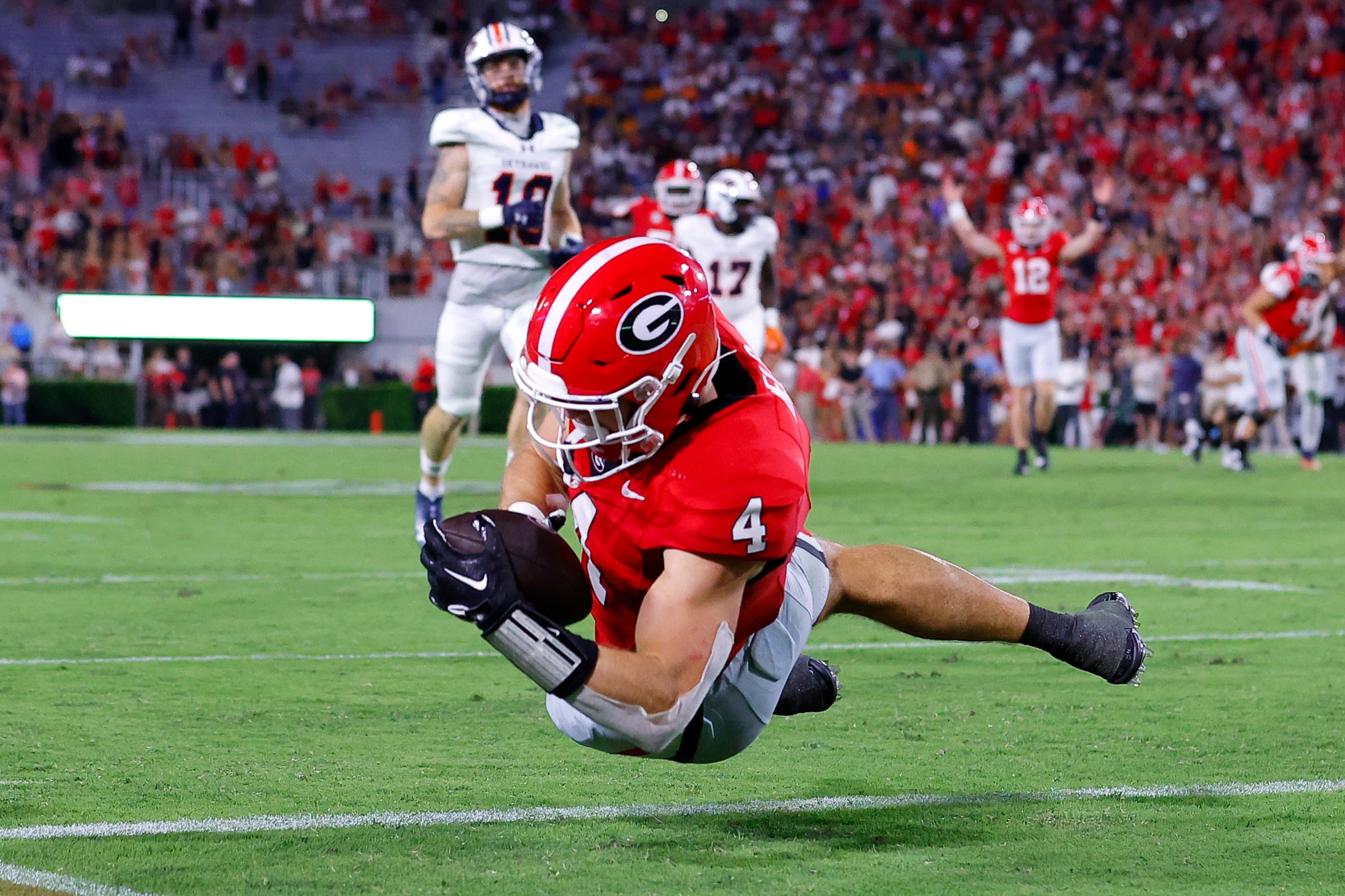 ATHENS, GEORGIA - SEPTEMBER 2: Oscar Delp #4 of the Georgia Bulldogs dives in for a touchdown during the fourth quarter against the Tennessee Martin Skyhawks at Sanford Stadium on September 2, 2023 in Athens, Georgia. (Photo by Todd Kirkland/Getty Images)