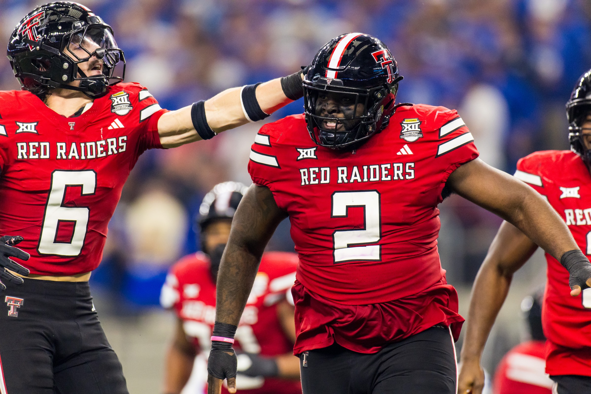 ARLINGTON, TEXAS - DECEMBER 06: John Curry #6 and Lee Hunter #2 of the Texas Tech Red Raiders celebrate during the first half the Big 12 Championship game against the BYU Cougars at AT&T Stadium on December 06, 2025 in Arlington, Texas. (Photo by John E. Moore III/Getty Images)