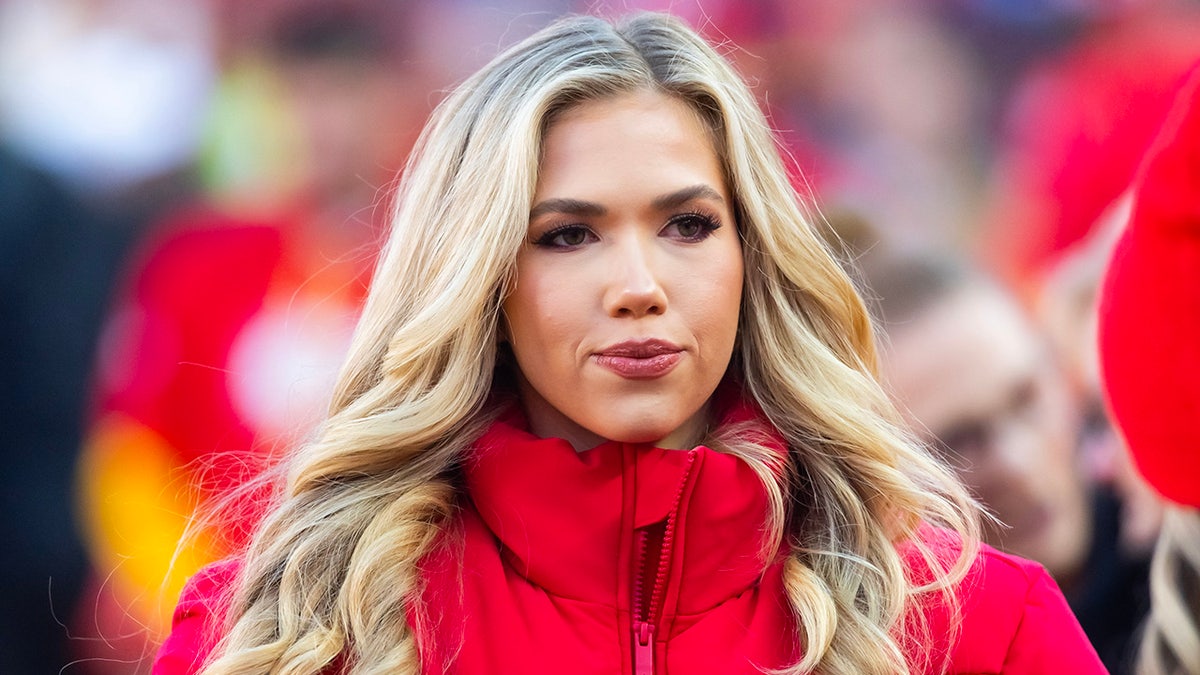 Gracie Hunt standing at GEHA Field at Arrowhead Stadium before an NFL game.