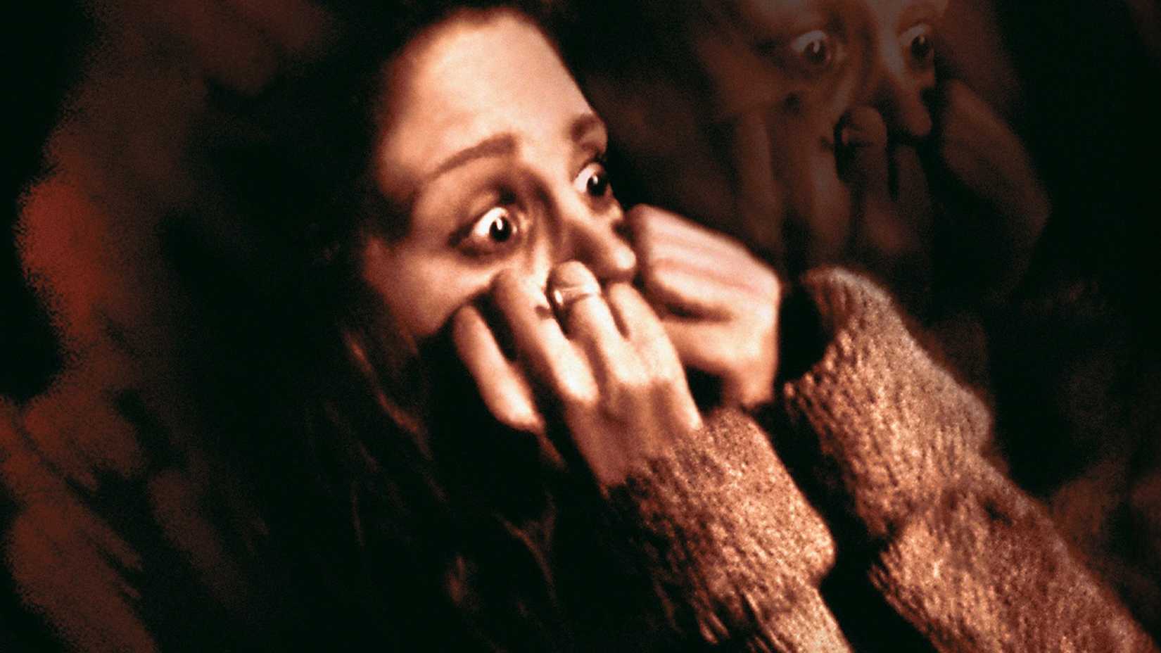 He Knows You're Alone poster shows a woman terrified