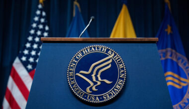 The seal of the Department of Health and Human Services is pictured on a podium before a news conference in April 2025.