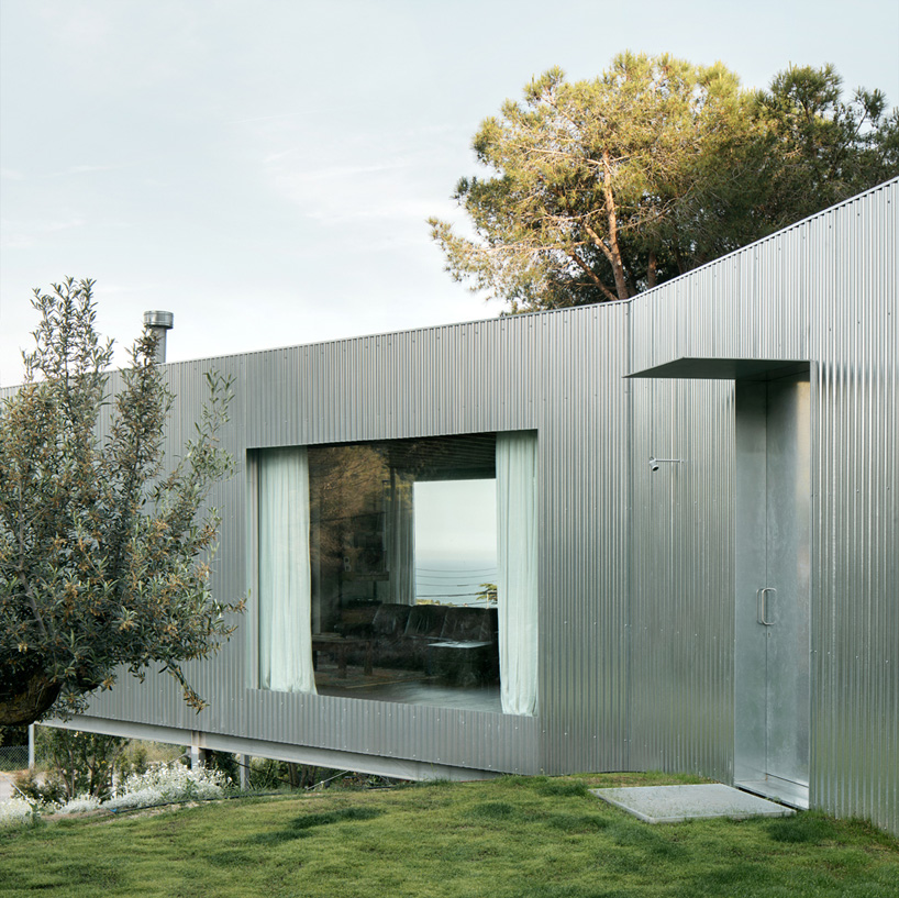 metallic house 144º rises on steel stilts above hillside near barcelona - 4