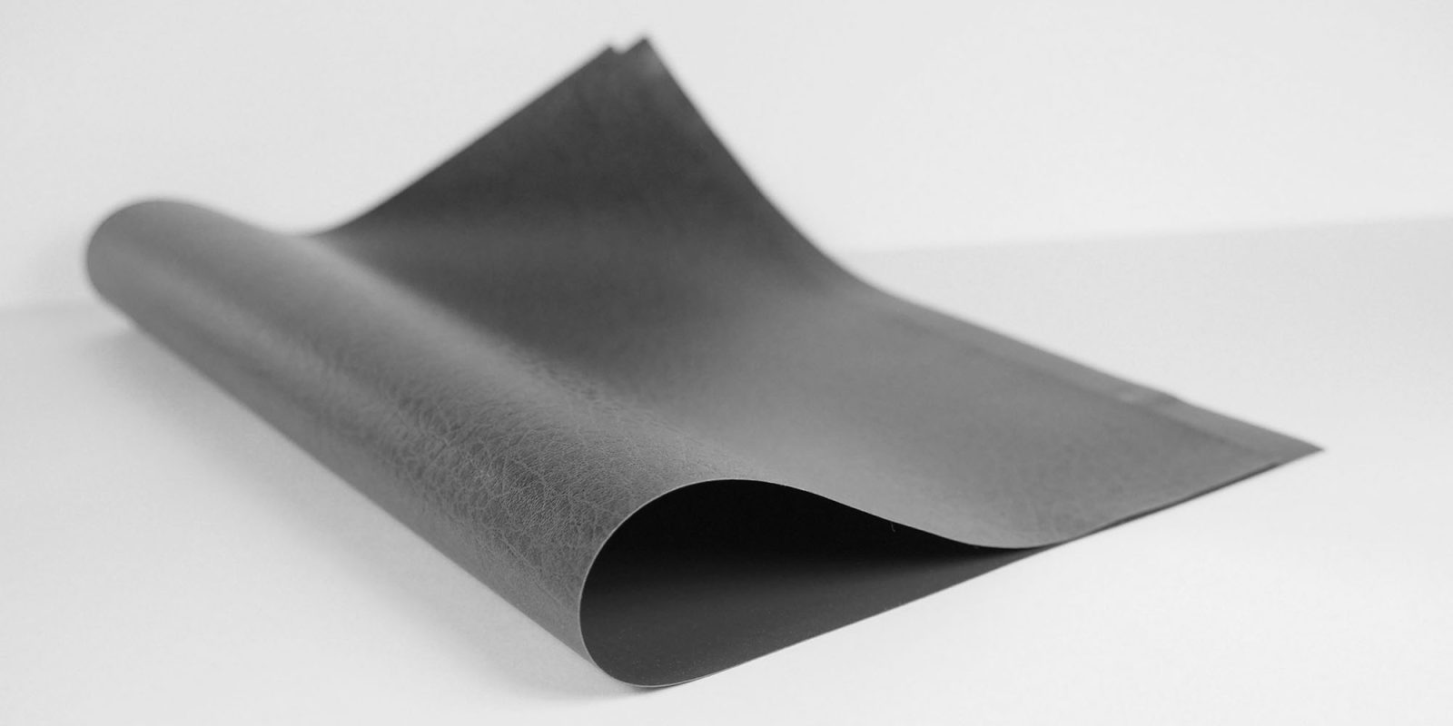 iPhone Fold unboxing video is a fake, not the real thing | Stock photo showing a piece of leather folded in two