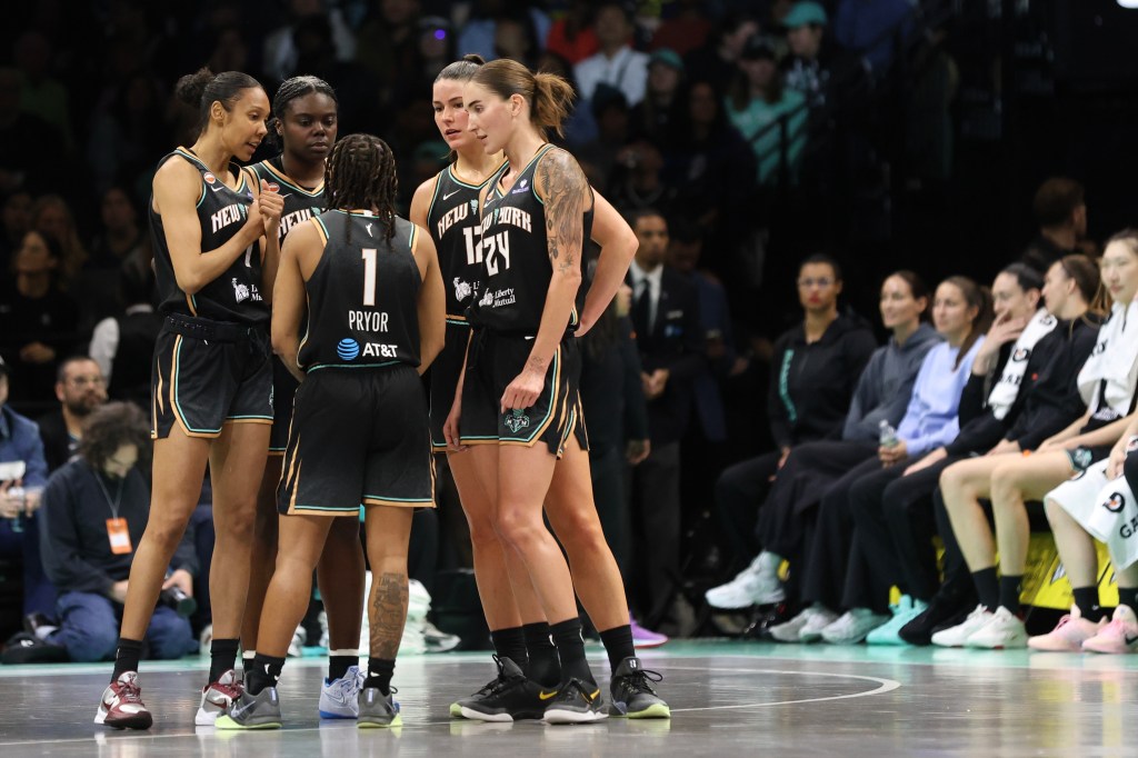 New York Liberty players huddle during a preseason WNBA game.