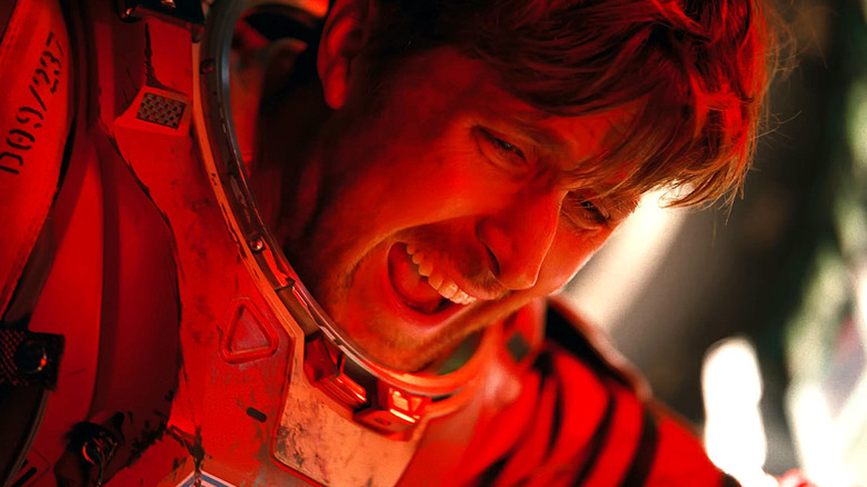Ryan Gosling as Ryland Grace wearing an astronaut suit and covered in a red light in Project Hail Mary