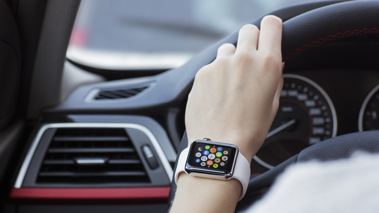 Person driving a car while wearing an Apple Watch