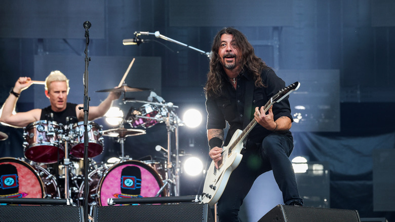 Foo Fighters performing on stage with Dave Grohl playing a white guitar