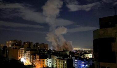 A smoke plume rises following a missile strike on a building in Tehran on March 1, 2026.