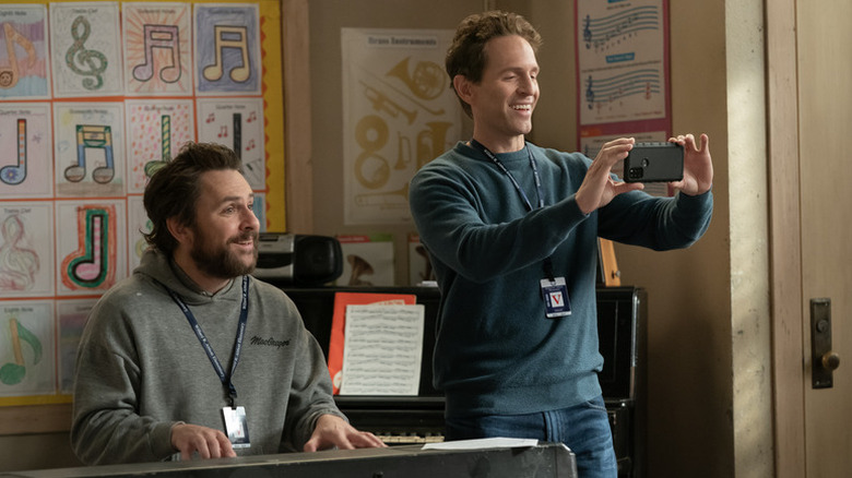 Charlie Kelly (Charlie Day) plays a keyboard while Dennis Reynolds (Glenn Howerton) films on his cellphone in It's Always Sunny in Philadelphia