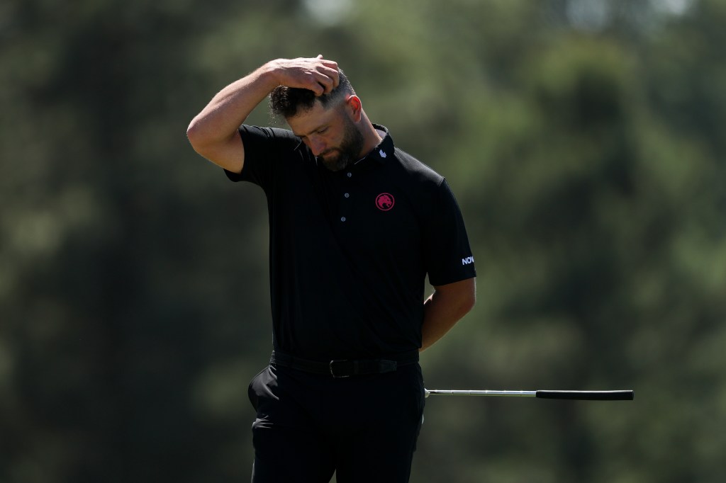 Jon Rahm of Spain reacts on the 18th green, holding his head, during the second round of the Masters Tournament.