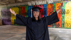 Kikila in front of mural