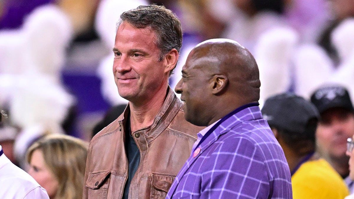 LSU head coach Lane Kiffin standing next to athletic director Verge Ausberry at NRG Stadium