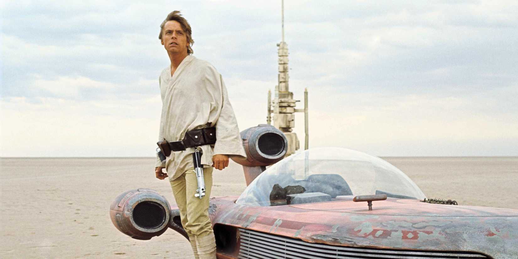 Luke Skywalker standing next to a speeder on Tatooine in A New Hope