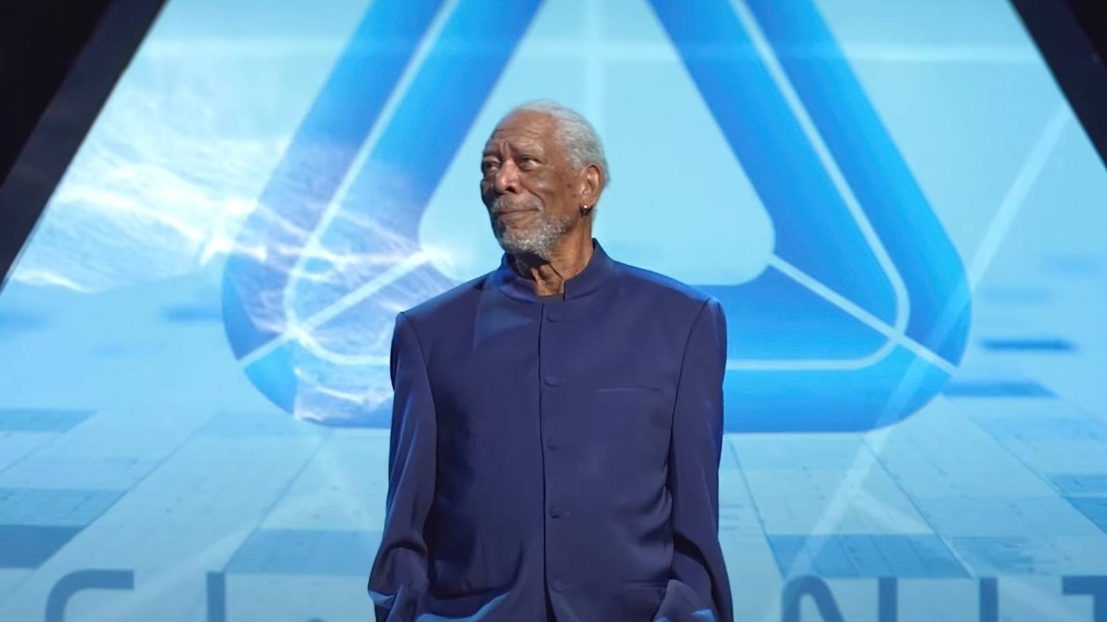Morgan Freeman stands on stage giving a presentation in 57 Seconds