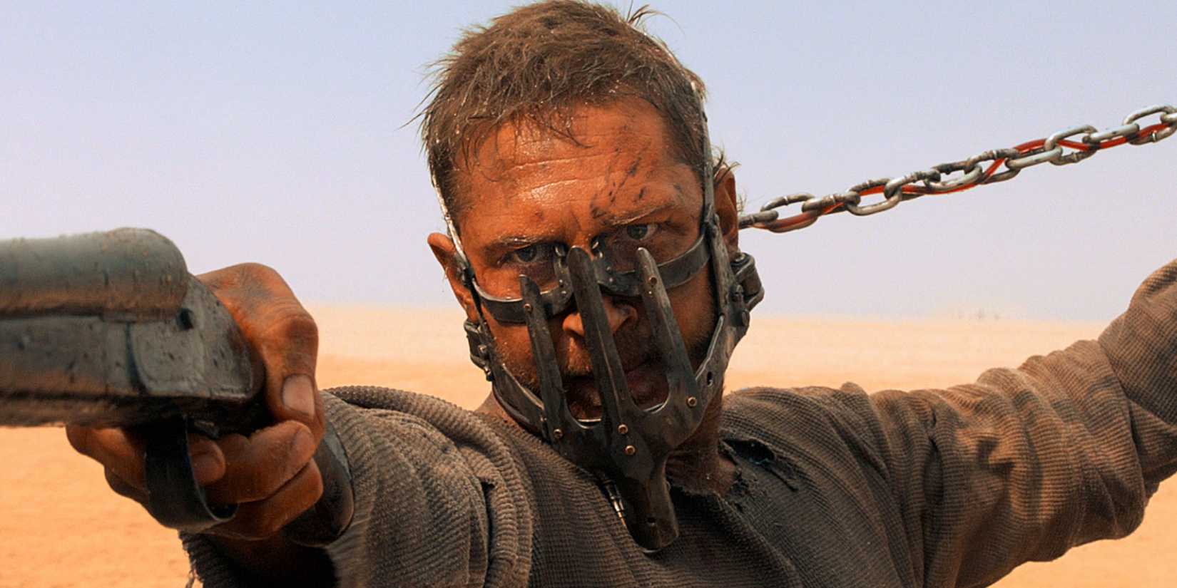 Max aiming a gun at someone off camera in Mad Max: Fury Road