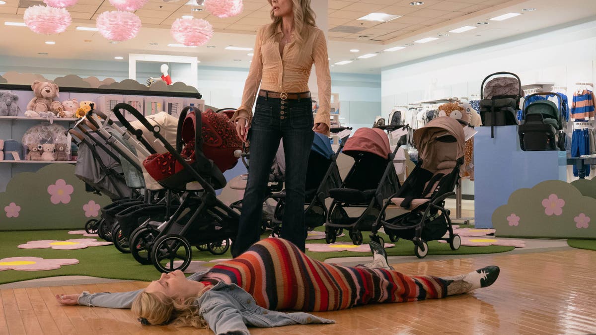 Michelle Pfeiffer standing over Elle Fanning lying on the floor in Margo's Got Money Troubles