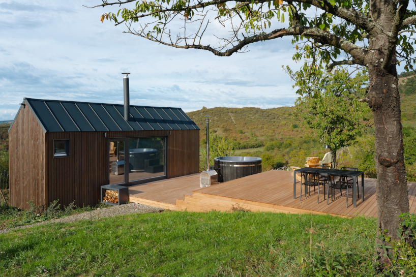 prefabricated timber micro-cabin extends living into the hungarian landscape - 4