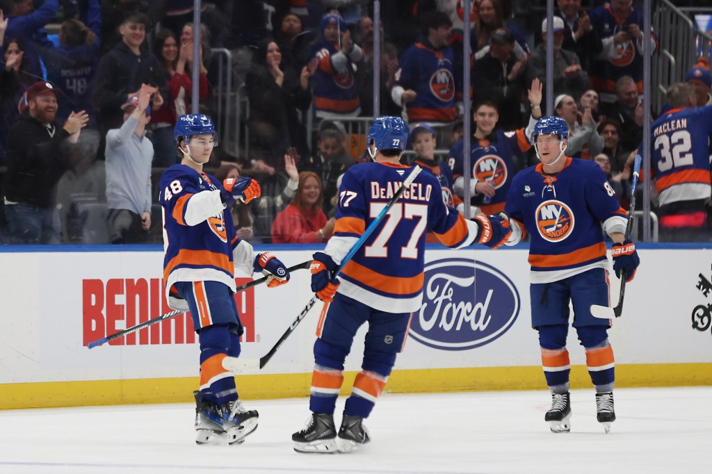 Islanders players celebrate a goal by defenseman Matthew Schaefer (48), left, during the second period of an NHL hockey game against the Toronto Maple Leafs in Elmont, N.Y. on Thursday, April 9, 2026.