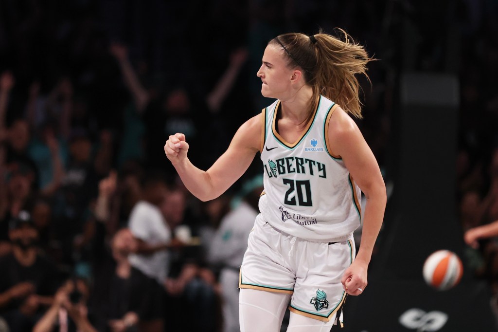Sabrina Ionescu reacting after scoring a three-point basket during a game.