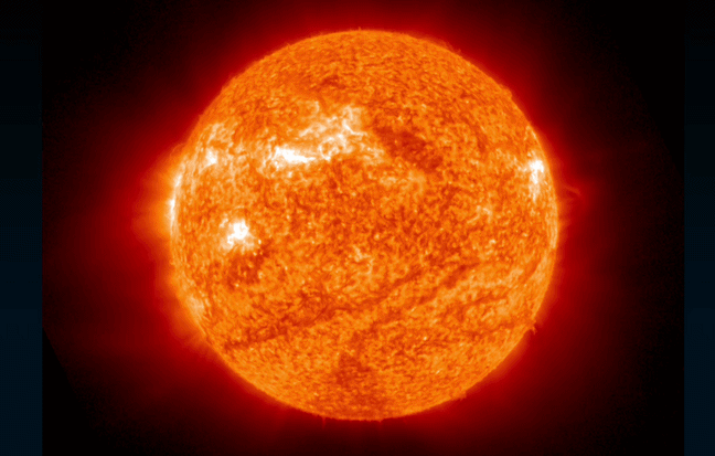 fiery solar flare erupts from the upper right of the sun.