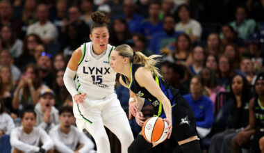Paige Bueckers #5 of the Dallas Mavericks drives to the basket against Jessica Shepard #15 of the Minnesota Lynx at Target Center.