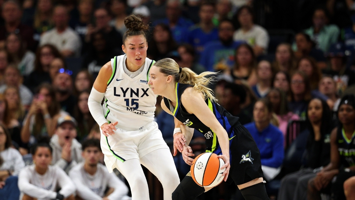 Paige Bueckers #5 of the Dallas Mavericks drives to the basket against Jessica Shepard #15 of the Minnesota Lynx at Target Center.