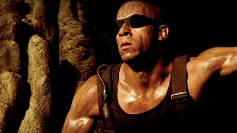 Vin Diesel as Richard B. Riddick wearing goggles to protect his surgically altered eye while in a cave in Pitch Black