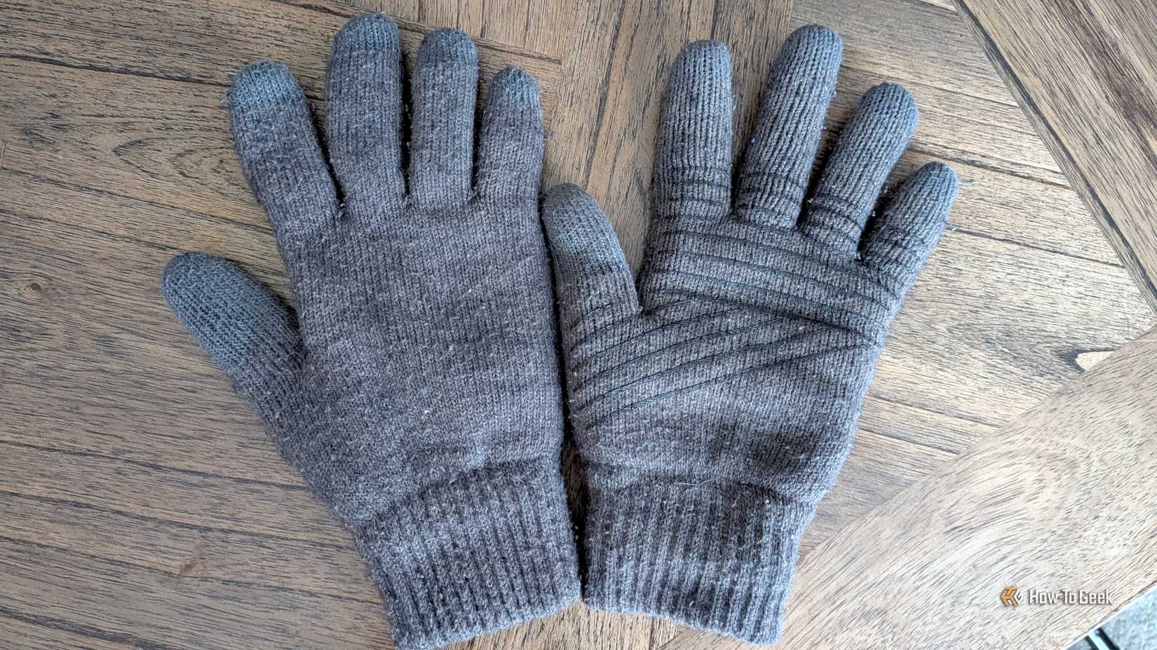 A pair of touchscreen gloves lying on a table. 