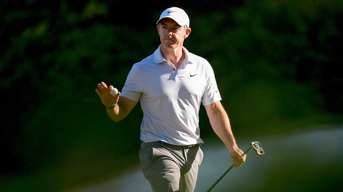 Rory McIlroy waving after a putt on the 13th hole at Augusta National Golf Club