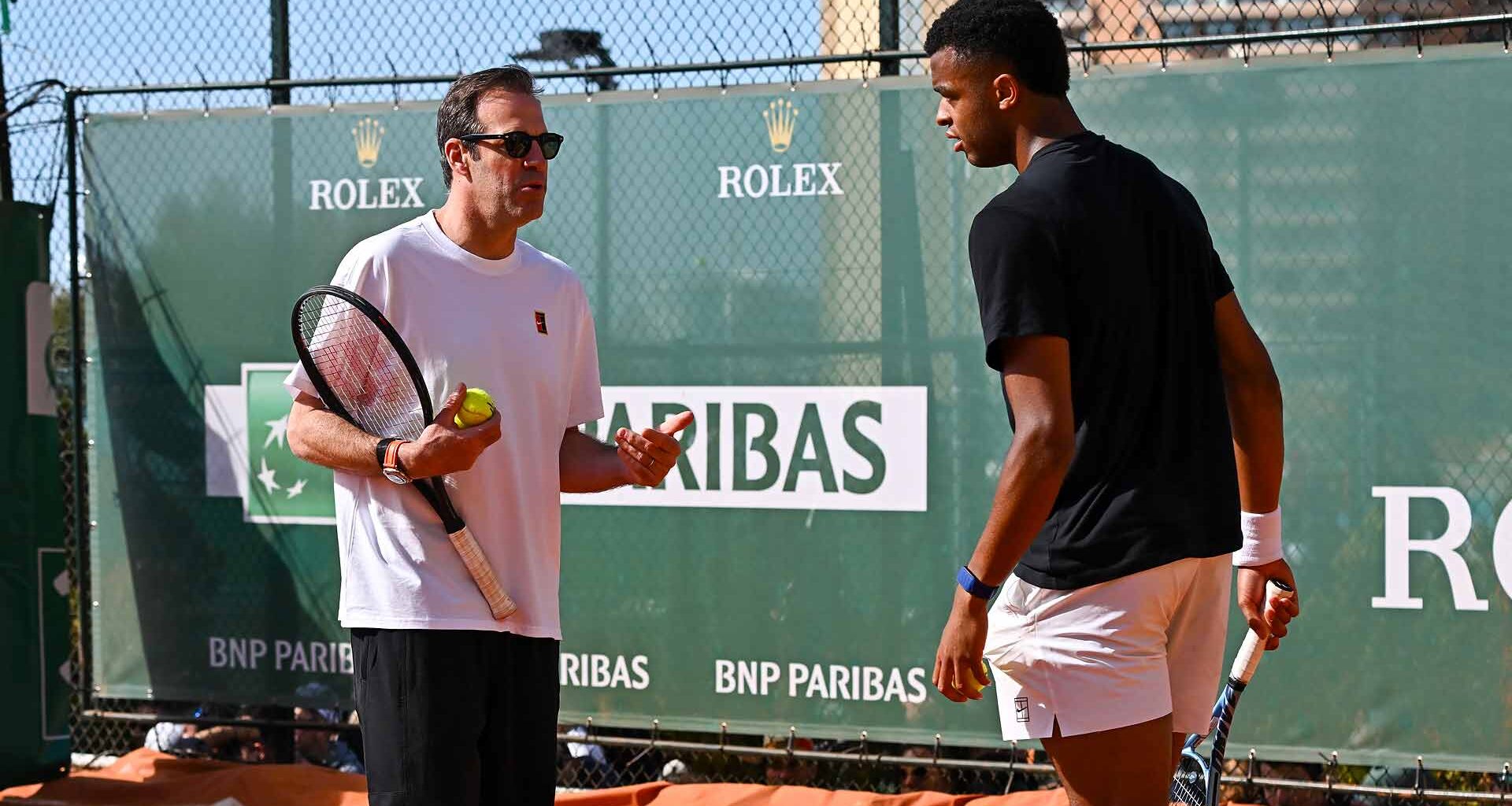Greg Rusedski and Giovanni Mpetshi Perricard chat during a training session Sunday in Monte-Carlo.