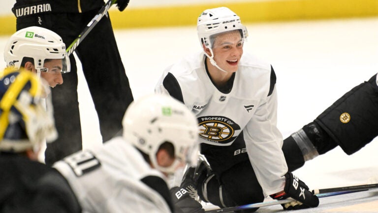 James Hagens, center, a Boston College center and the Bruins’ 7th overall draft pick, stretches with teammates at the conclusion of the first day of Bruins Development Camp at Warrior Arena in Brighton on Monday, June 30, 2025.