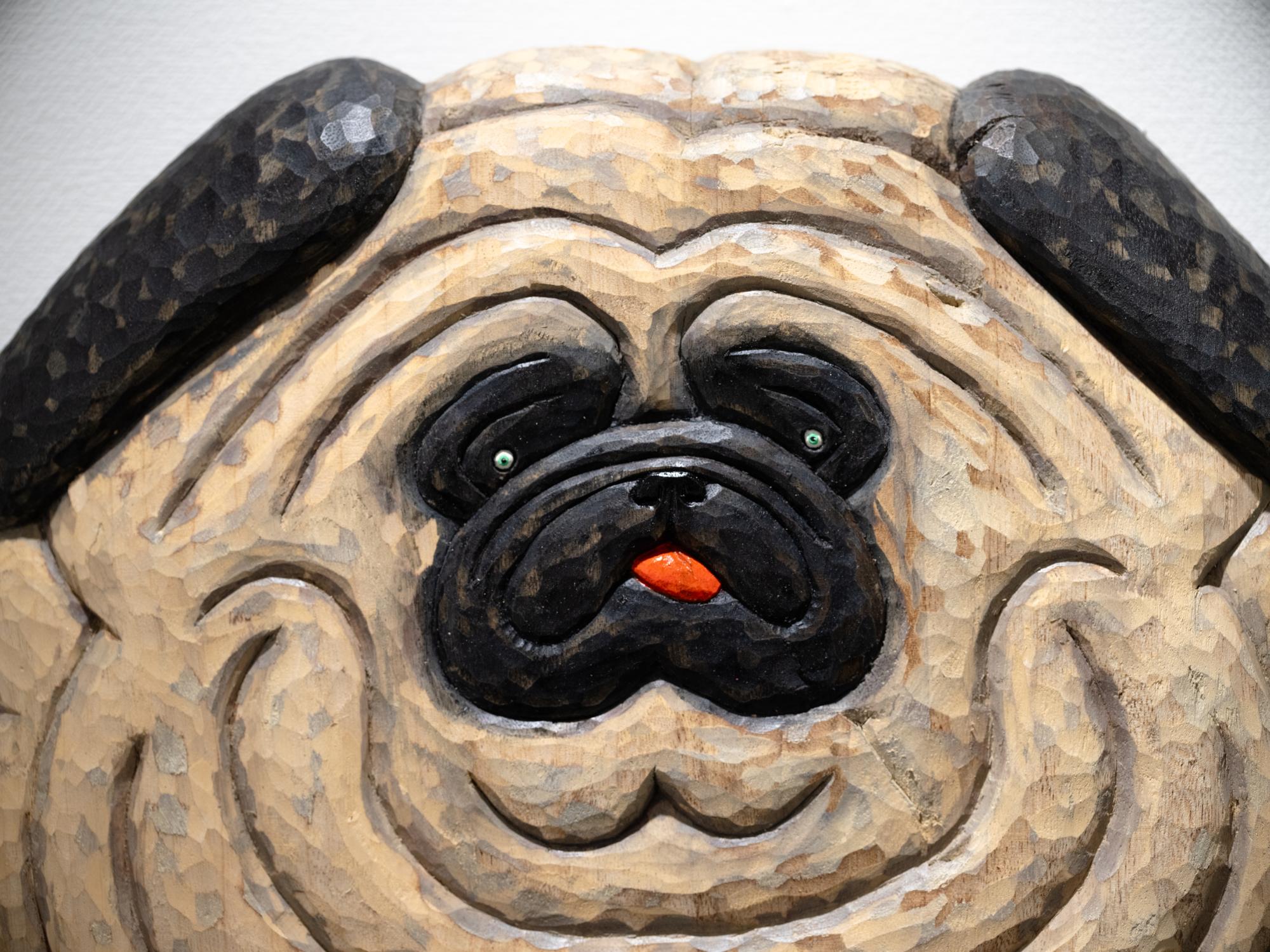 face details of a wood-carved pug sculpture by Misato Sano