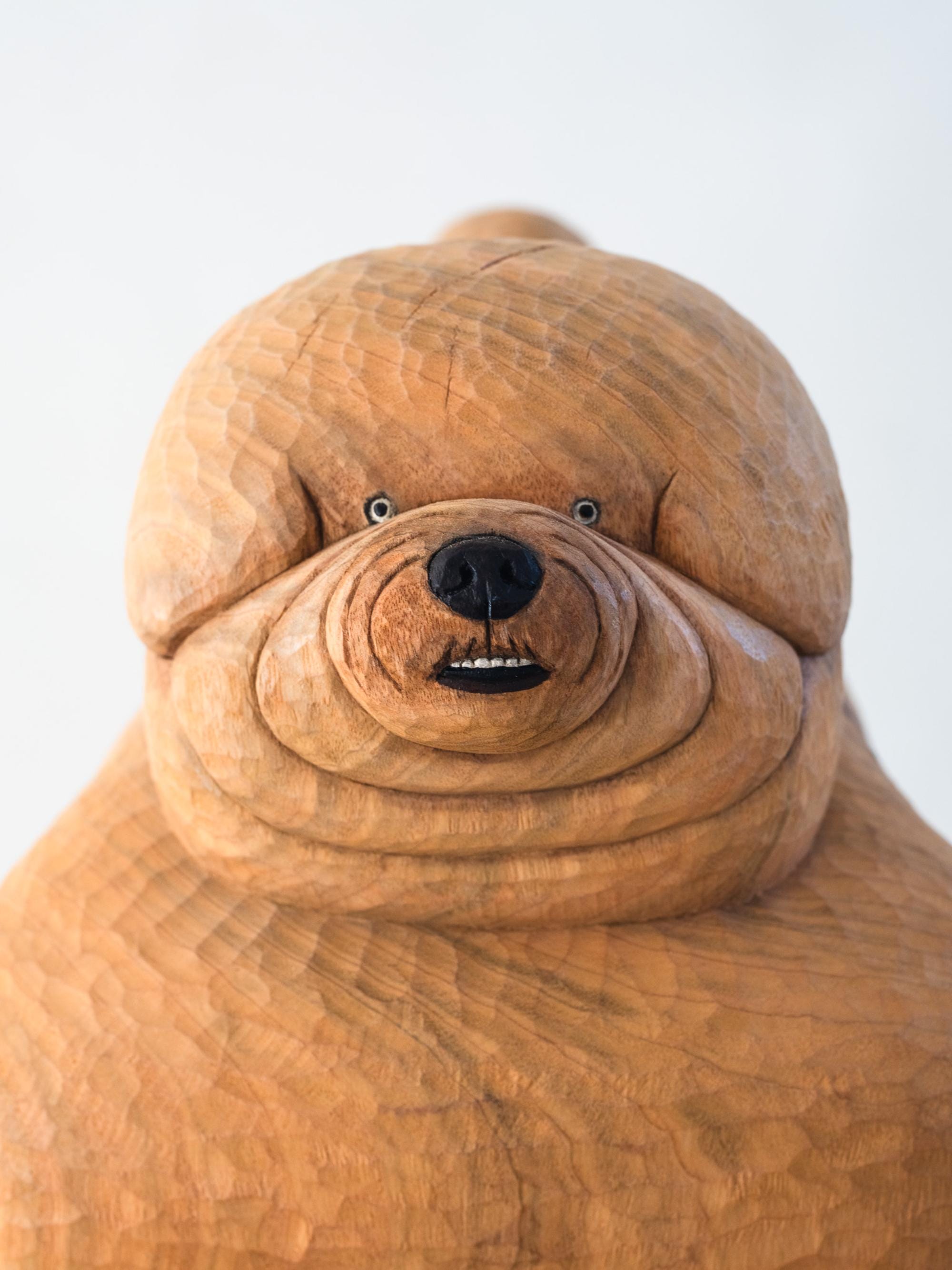 face details of a wood-carved dog sculpture dog by Misato Sano