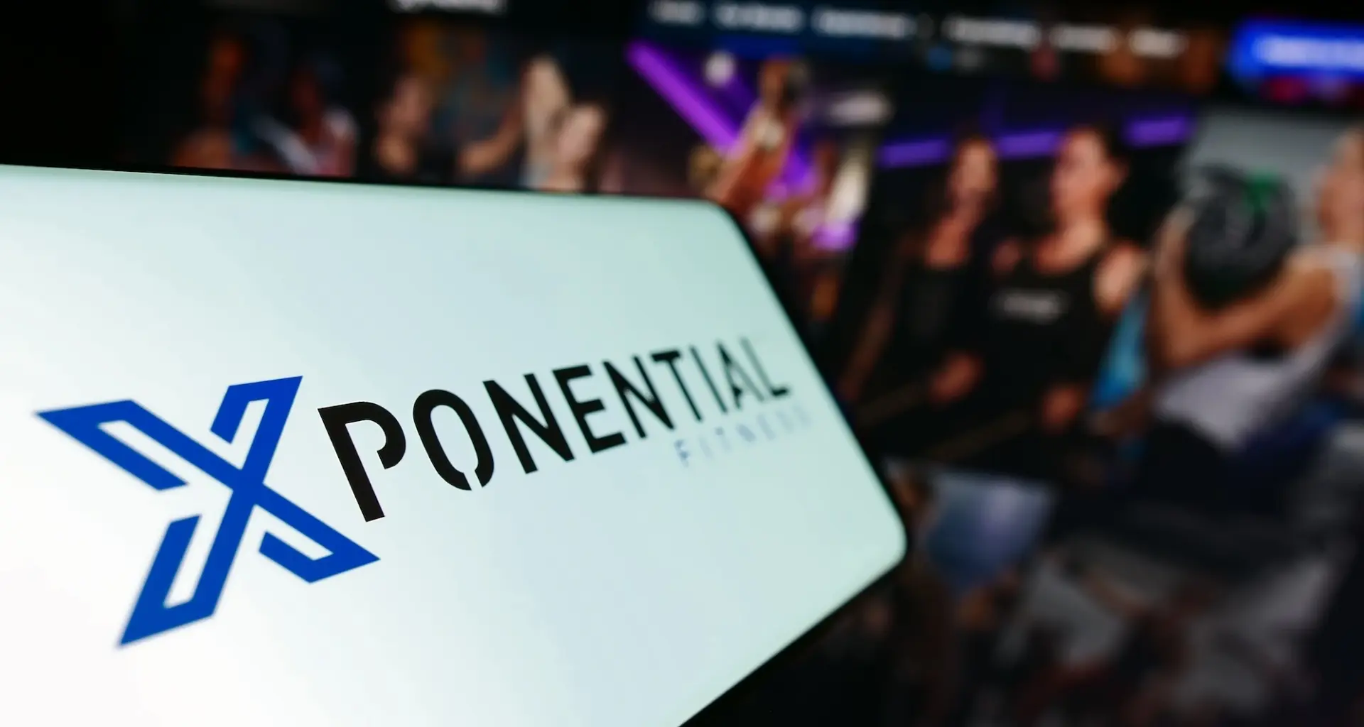 phone shows an Xponential Fitness logo