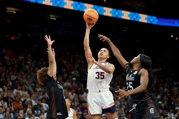UConn forward Azzi Fudd shoots between South Carolina defenders Maddy McDaniel, left, and Raven Johnson in the Gamecocks' Final Four victory at Mortgage Matchup Center on April 03, 2026 in Phoenix. (Photo by Sarah Stier/Getty Images)