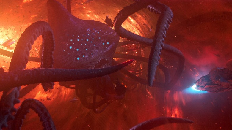 A Summa-Verminoth pursues the Millennium Falcon through a nebula in Solo: A Star Wars Story