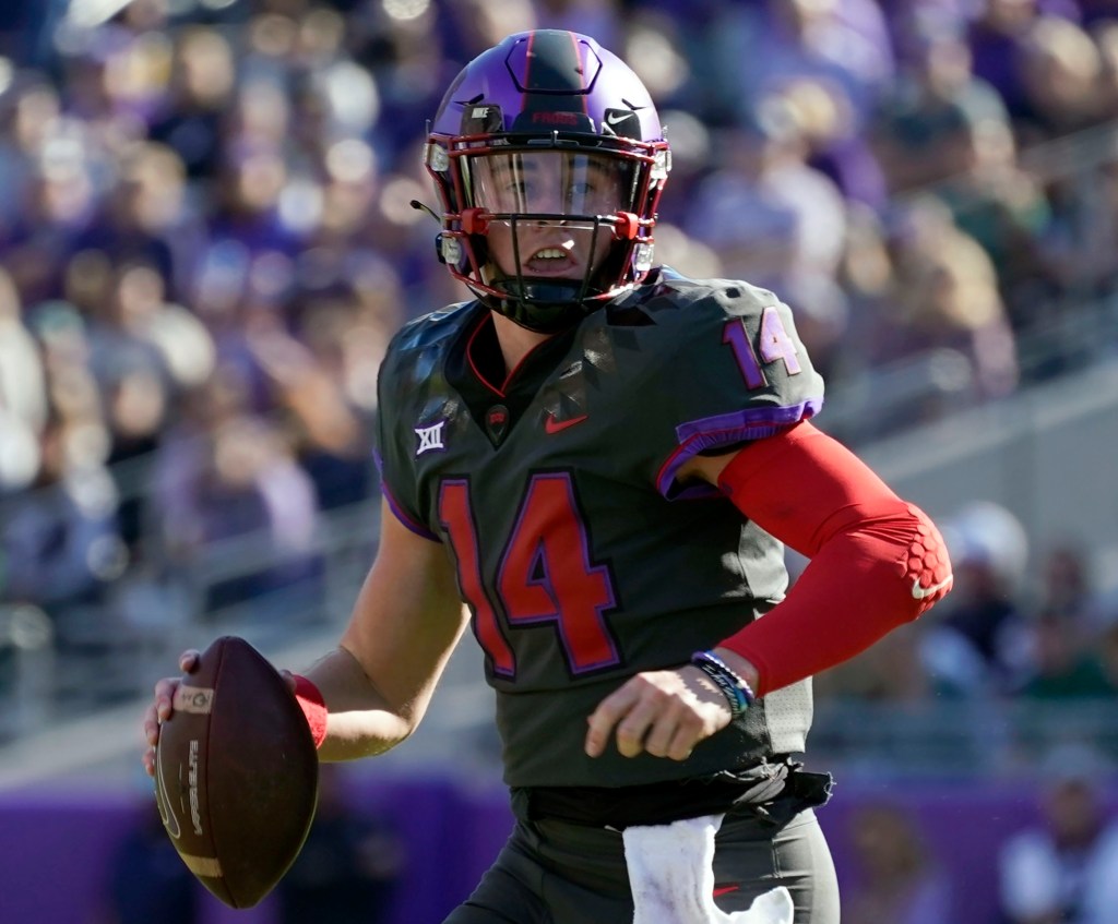 TCU quarterback Chandler Morris scrambles out of the pocket during a college football game.