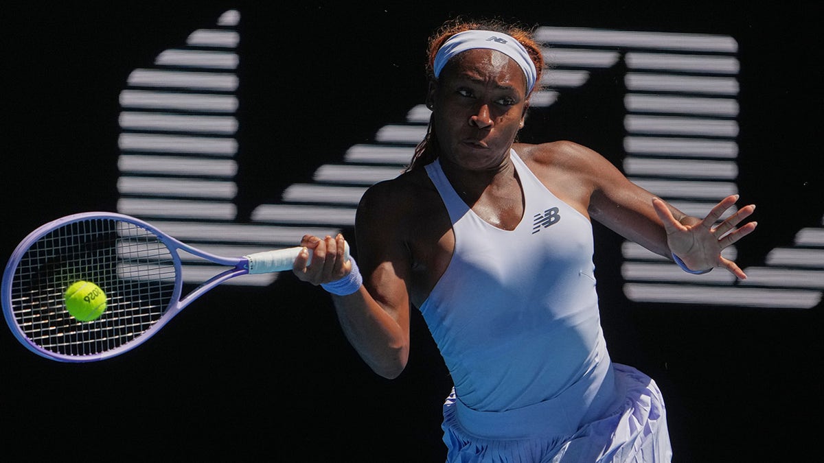 Coco Gauff hitting a forehand return during a tennis match in Melbourne