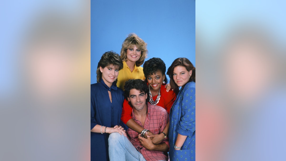 Nancy McKeon, Lisa Whelchel, Kim Fields, Mindy Cohn, and George Clooney embracing warmly