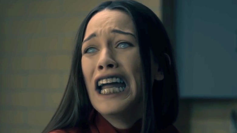 Carla Gugino as Olivia Crain, screaming with ghostly features in The Haunting of Hill House.