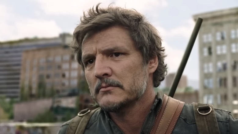 Pedro Pascal as Joel Miller, staring out with a rife on his back in The Last of Us.